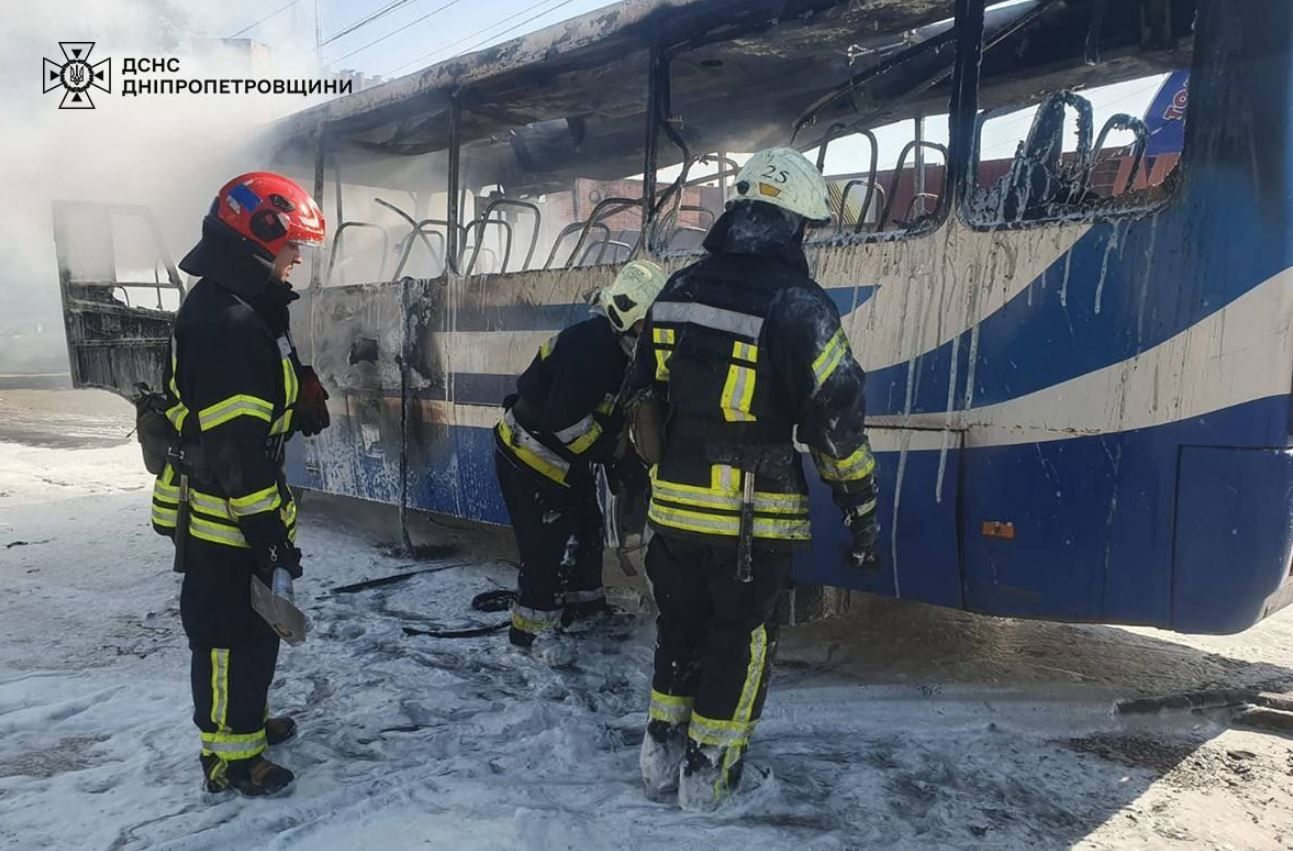 Рятувальники оглядають понівечений вогнем автоубс