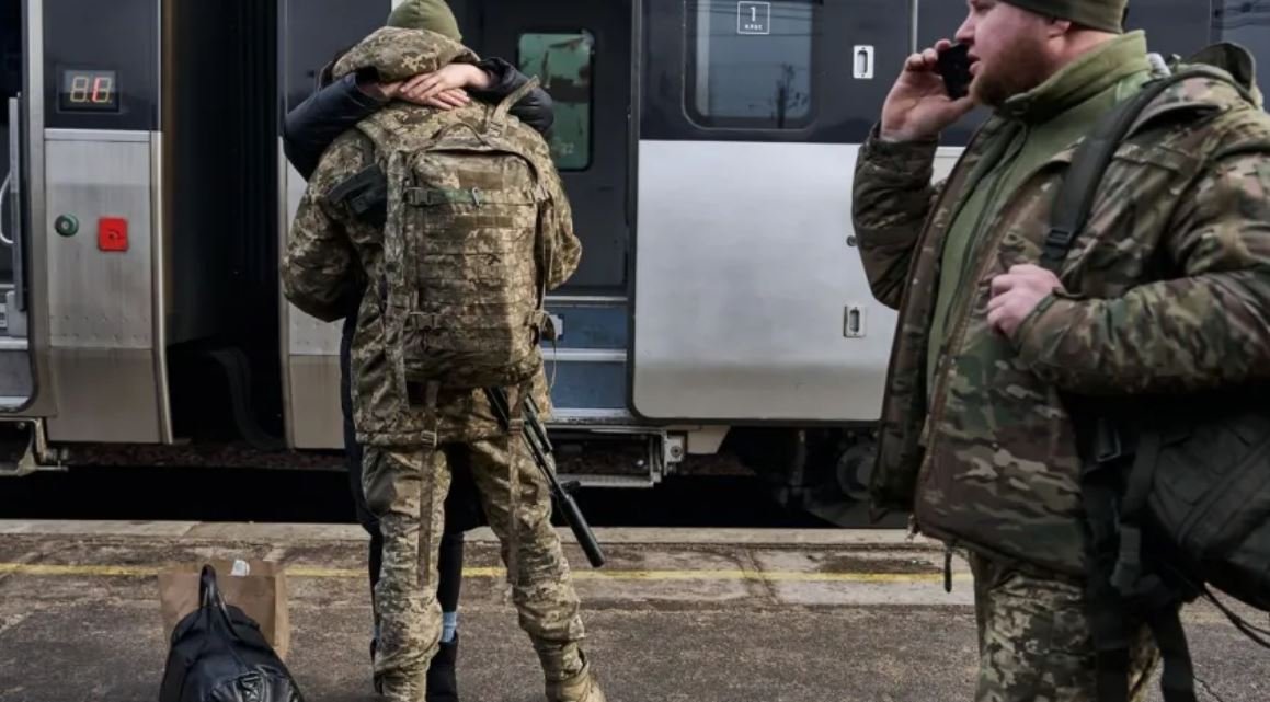 Мобілізовані чоловіки біля потяга 