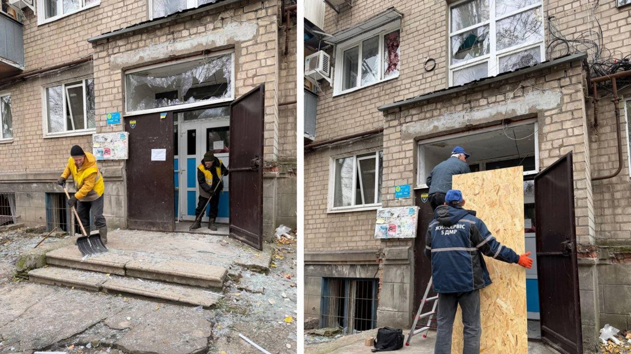 Комунальники біля будинку, який пошкоджено через атаку дронів на Дніпро