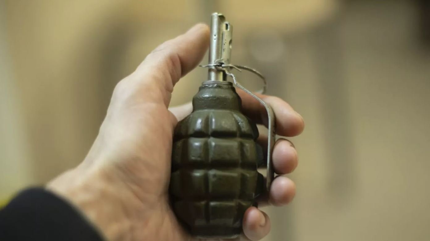 Чоловік тримає гранату в руках